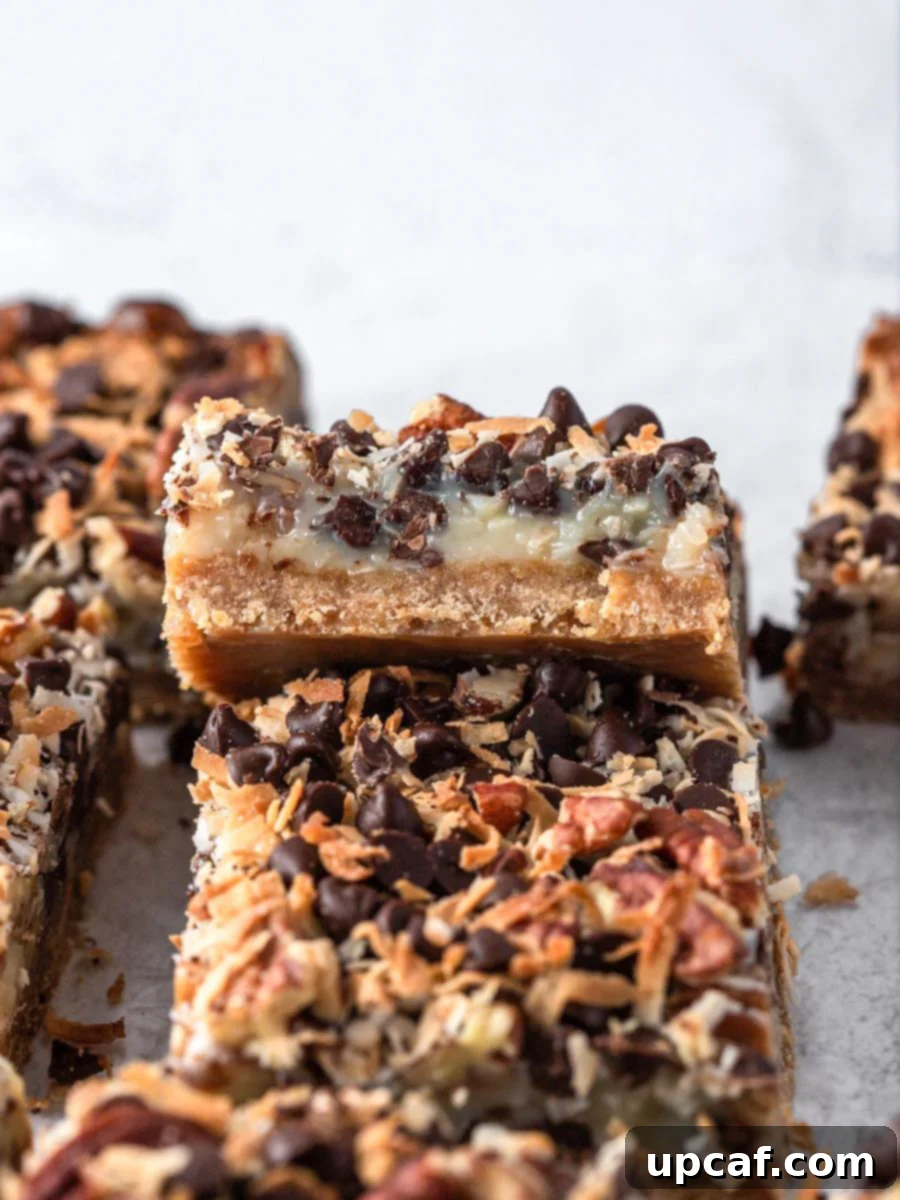 Golden Coconut Dream Bars 3 Freshly baked magic bars cooling in a pan, with a perfectly browned top layer of coconut and chocolate.