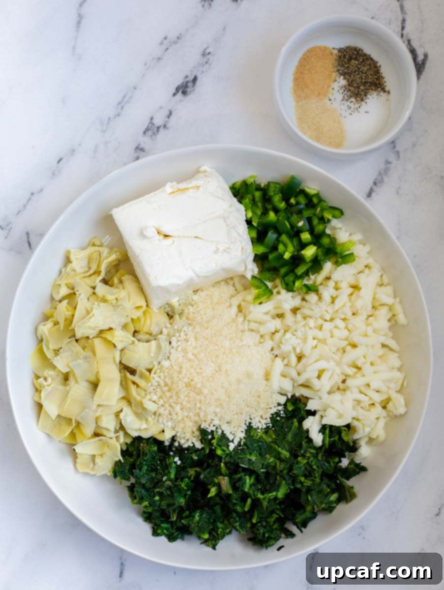Creamy Spinach Artichoke Stuffed Chicken 3 Overhead shot of cheesy spinach stuffing ingredients for the recipe.