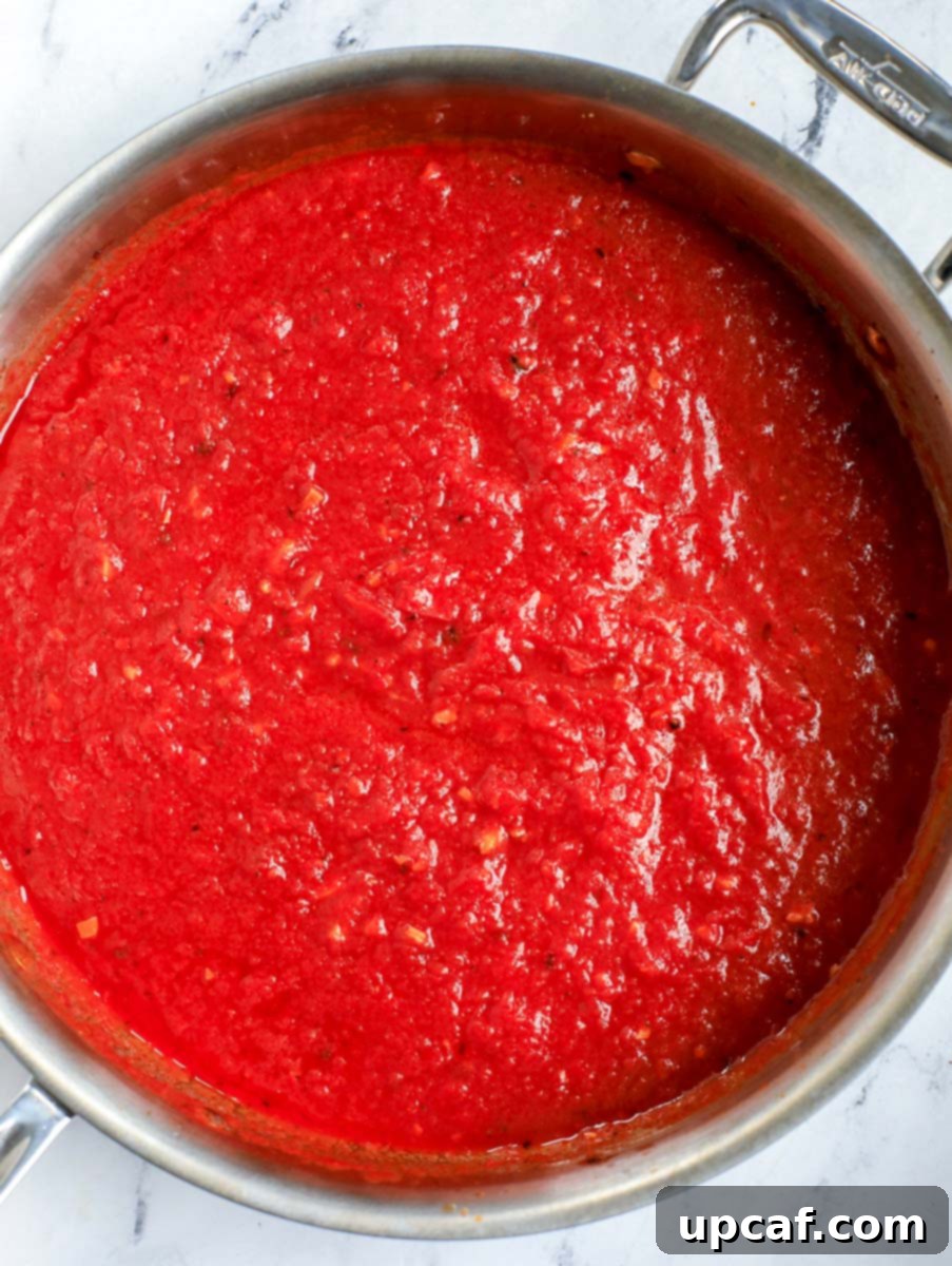Raging Inferno Pasta 9 Top down shot of the tomato sauce simmering in a pot.