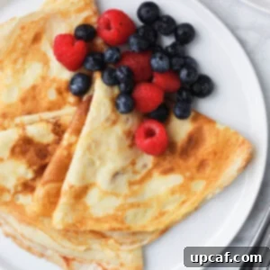 crepes and berries served on a plate