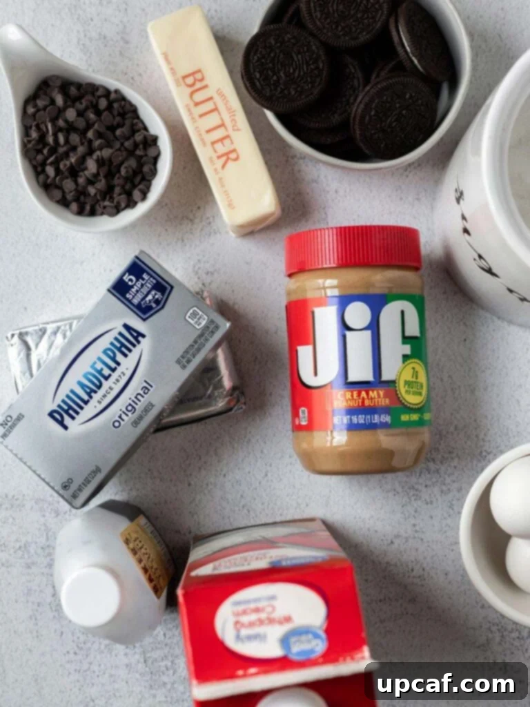 A top-down shot showing all the essential ingredients laid out for making the Chocolate Peanut Butter Cheesecake Bars, including Oreos, cream cheese, peanut butter, and chocolate chips.