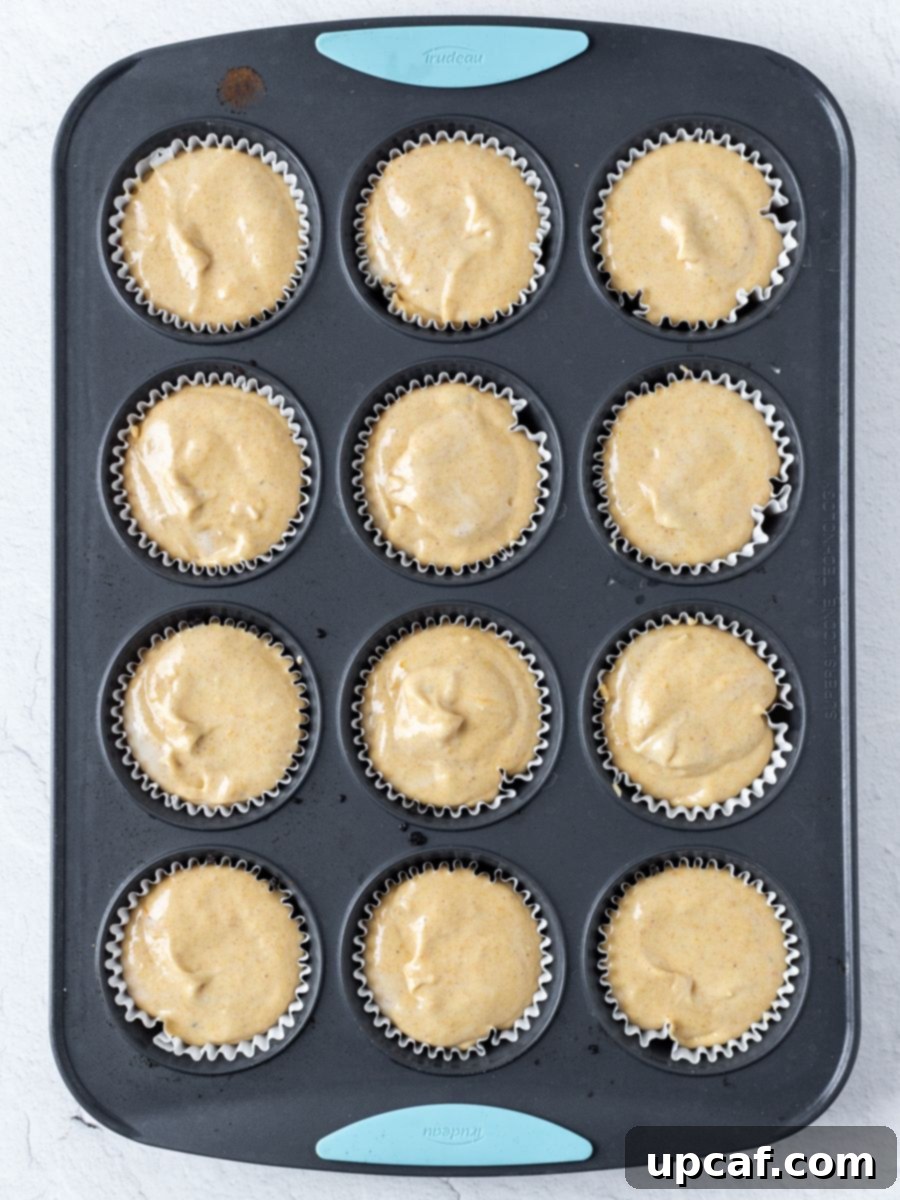 Top down shot of mini pumpkin cheesecakes in a mold. 