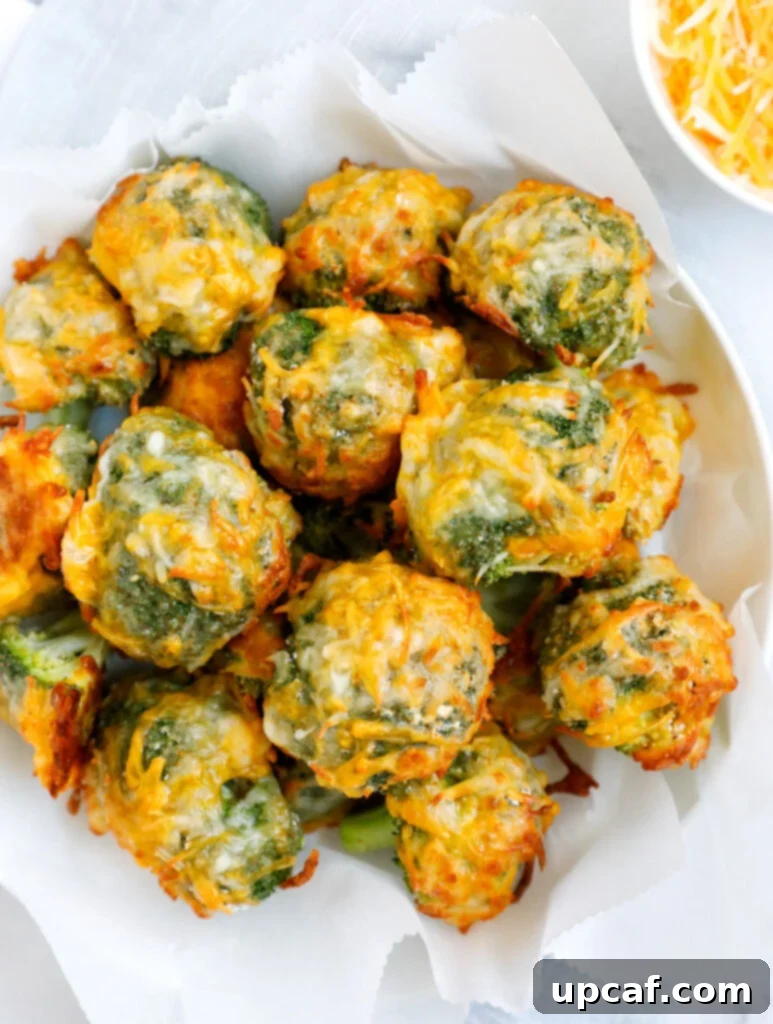 Overhead shot of cheesy broccoli bites on a white bowl.