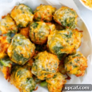 Overhead shot of cheesy broccoli bites on a white bowl.