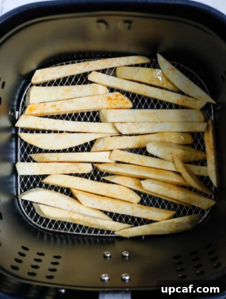 Top down shot of sweet potato slices in the air fryer.