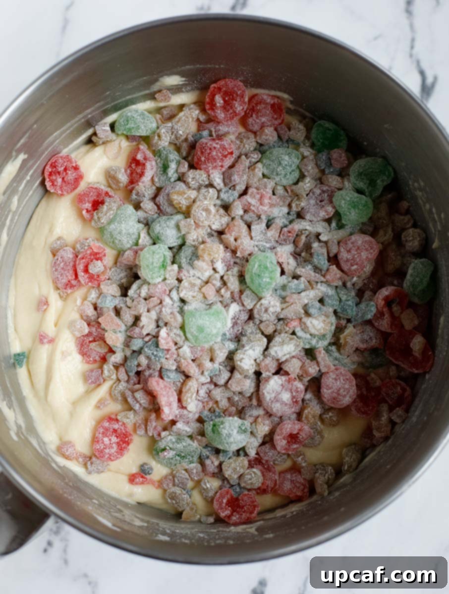 Zesty Holiday Fruitcake 14 The flour-coated dried fruits being carefully added into the thick cake batter.