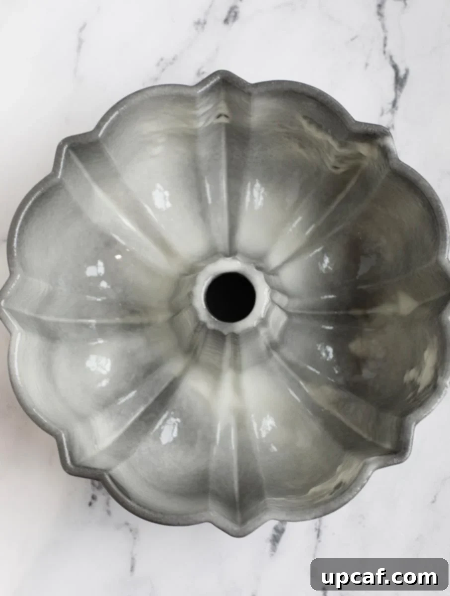 Zesty Holiday Fruitcake 16 A Bundt cake pan thoroughly coated with non-stick baking spray, ensuring easy release.