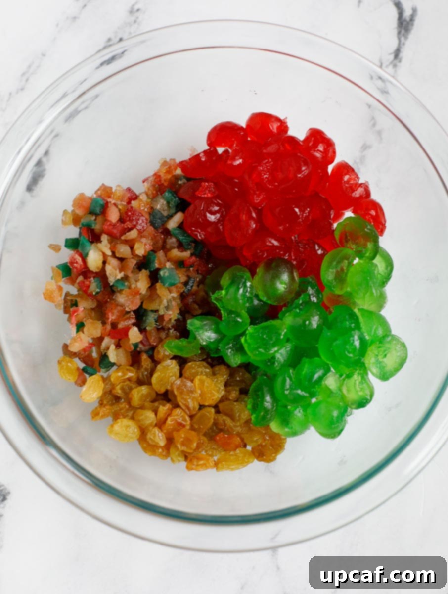 Zesty Holiday Fruitcake 5 A mix of various colorful dried fruits in a bowl, prepared for the fruit cake recipe.