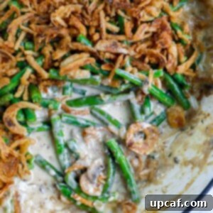 Ultimate Homestyle Green Bean Casserole 11 Homemade Green Bean Casserole with a portion removed, showing texture.