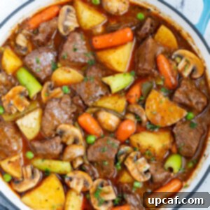 Top down view of best beef stew in a blue pot.