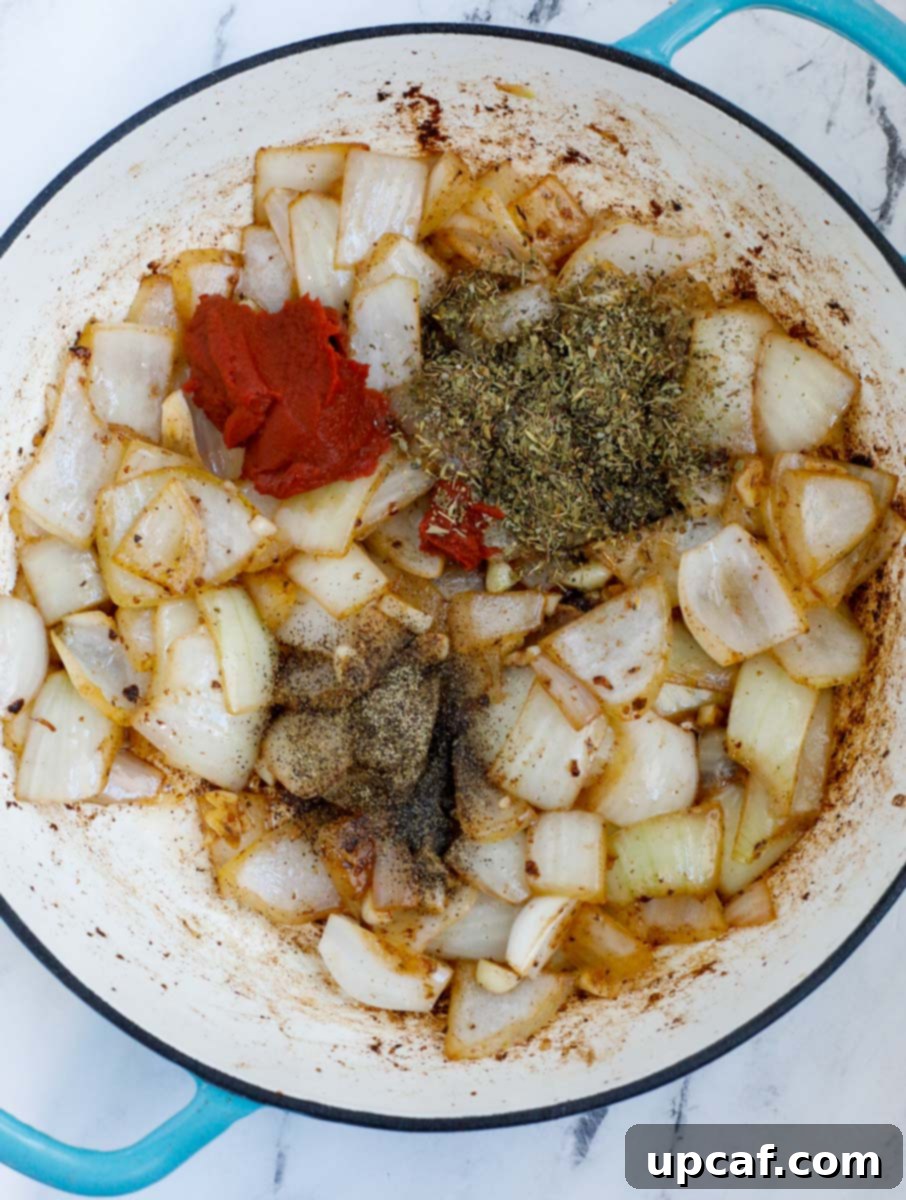 Onions and seasoning in a dutch oven