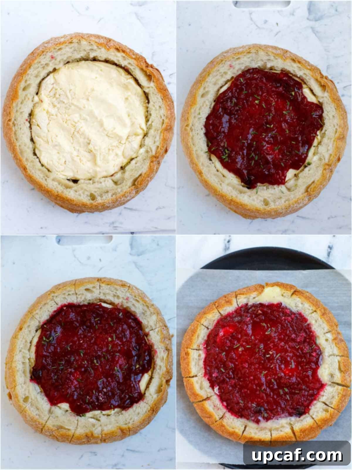Cranberry Brie Bread Bake 5 A partially assembled cranberry brie bread bowl, showing a wheel of brie placed inside the hollowed bread, topped with cranberry sauce and fresh herbs, ready for baking.