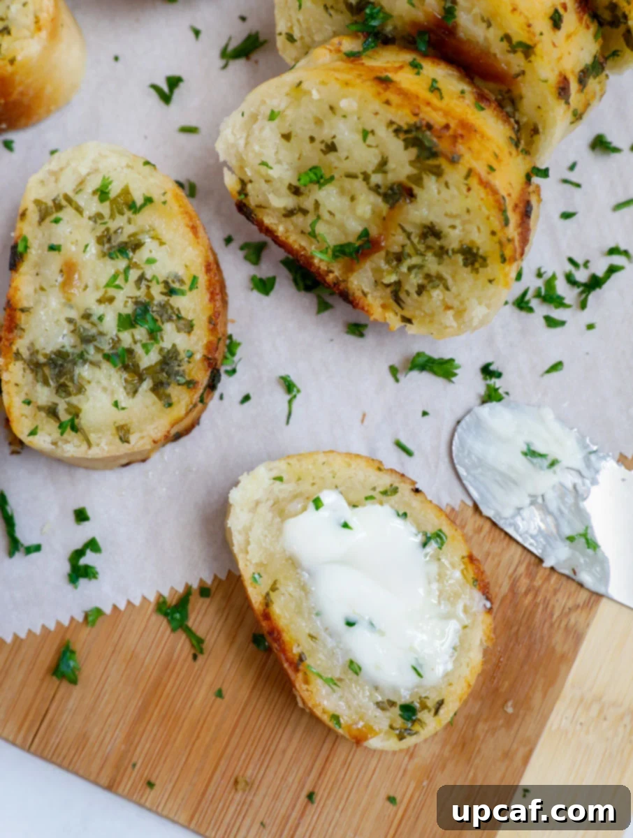 Top down shot of sliced easy garlic bread on parchment. 
