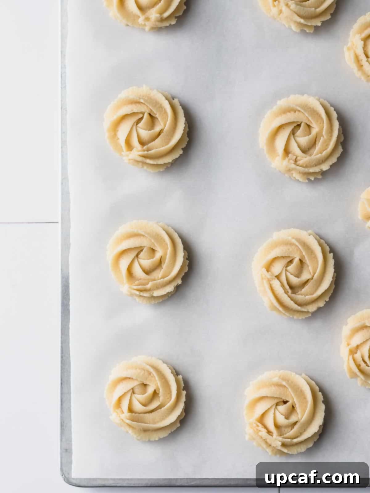 uncooked danish cookies piped in a pan