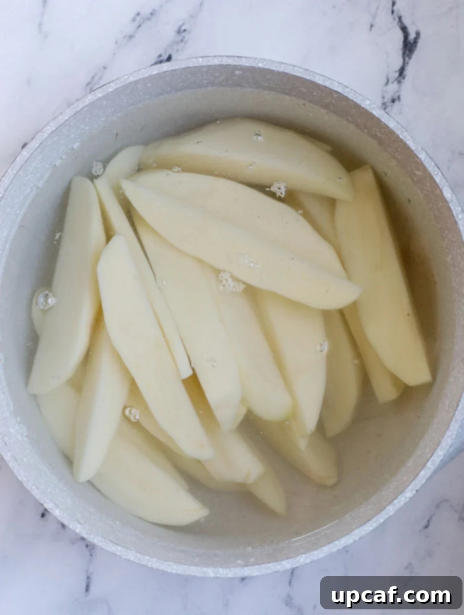 potatoes in pot with water, ready to boil