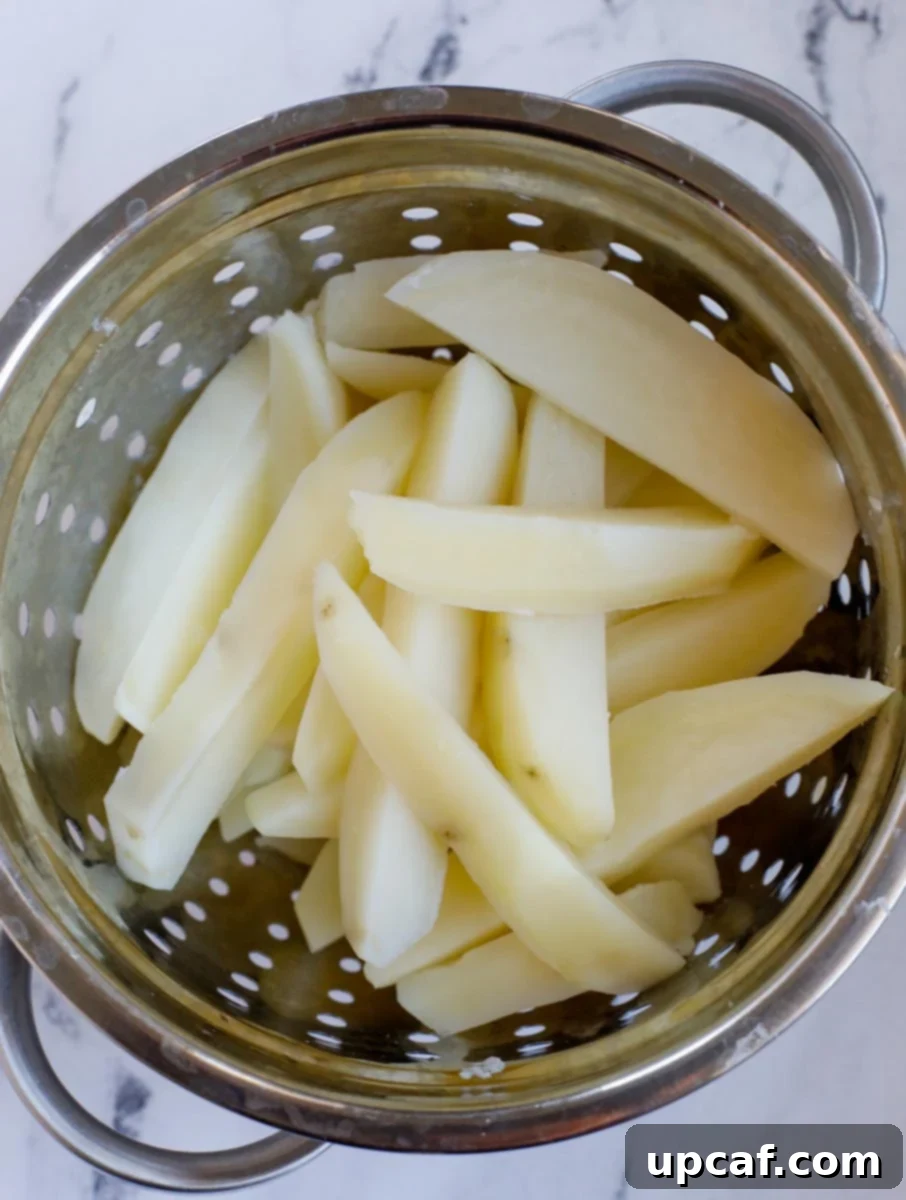 Draining potato slices in a colander.