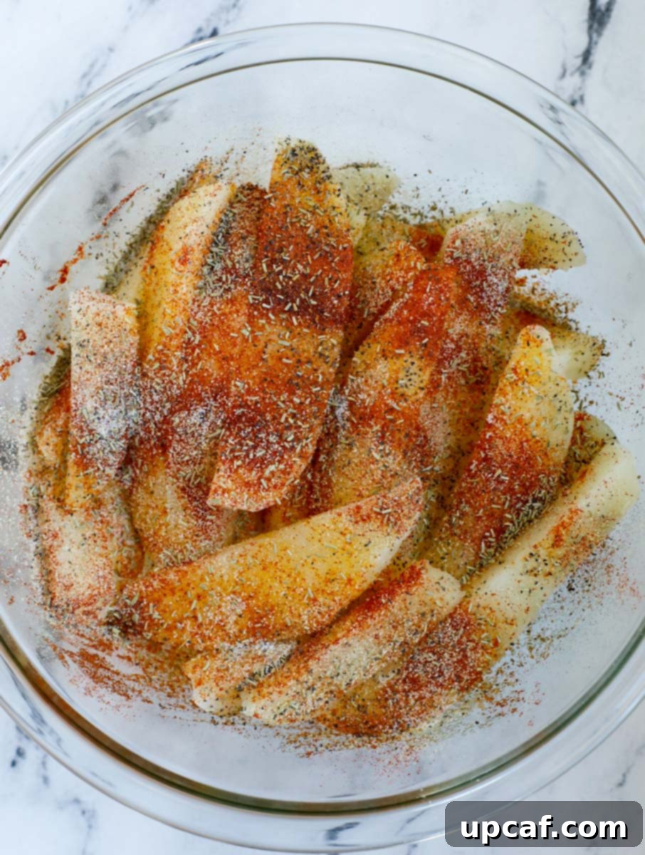 Potato slices and seasoning in a bow.