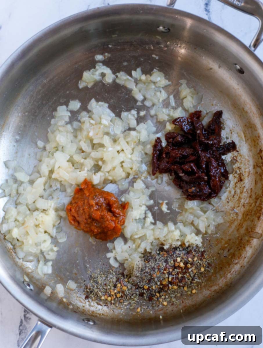 Garlic and spices being sautéed in a skillet.