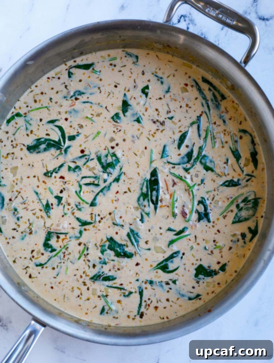 Fresh spinach and cream mixed in a pot.