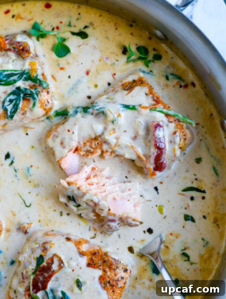 Overhead shot of creamy tuscan salmon in a skillet, ready to be served.