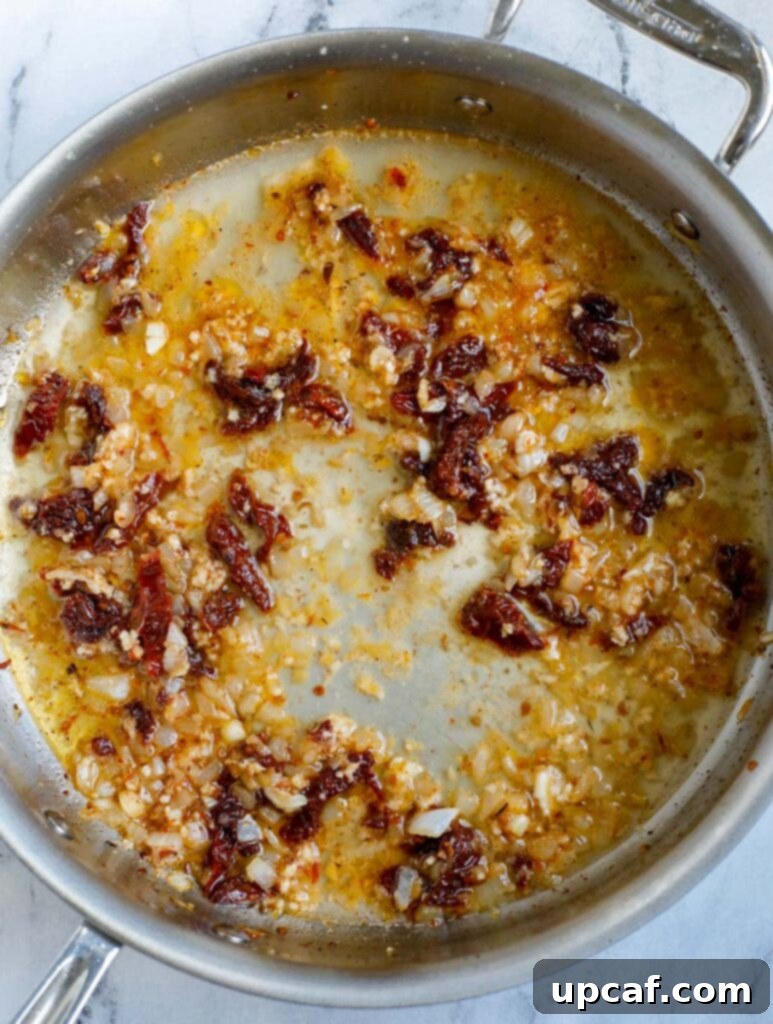 Vegetable broth being poured into the skillet with aromatics.