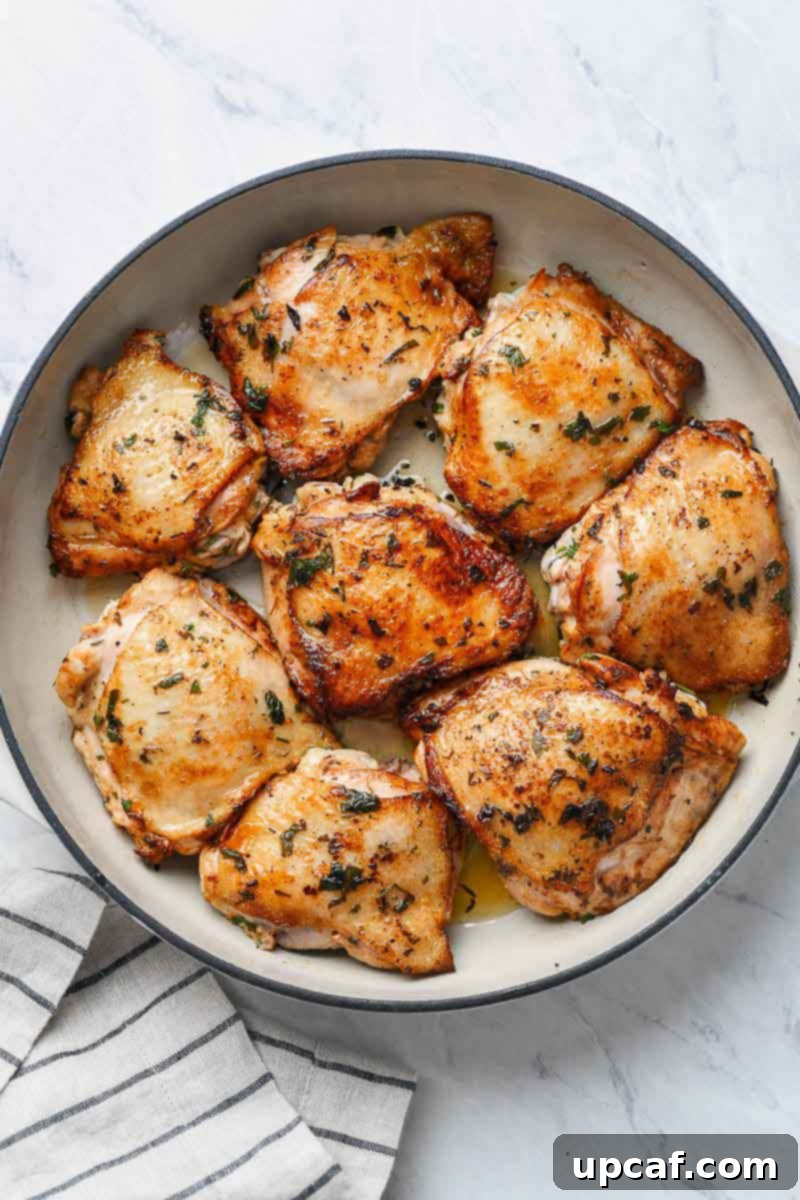 Zesty Lemon Cilantro Chicken 3 Pan seared chicken thighs in a skillet, showing a golden brown crust.