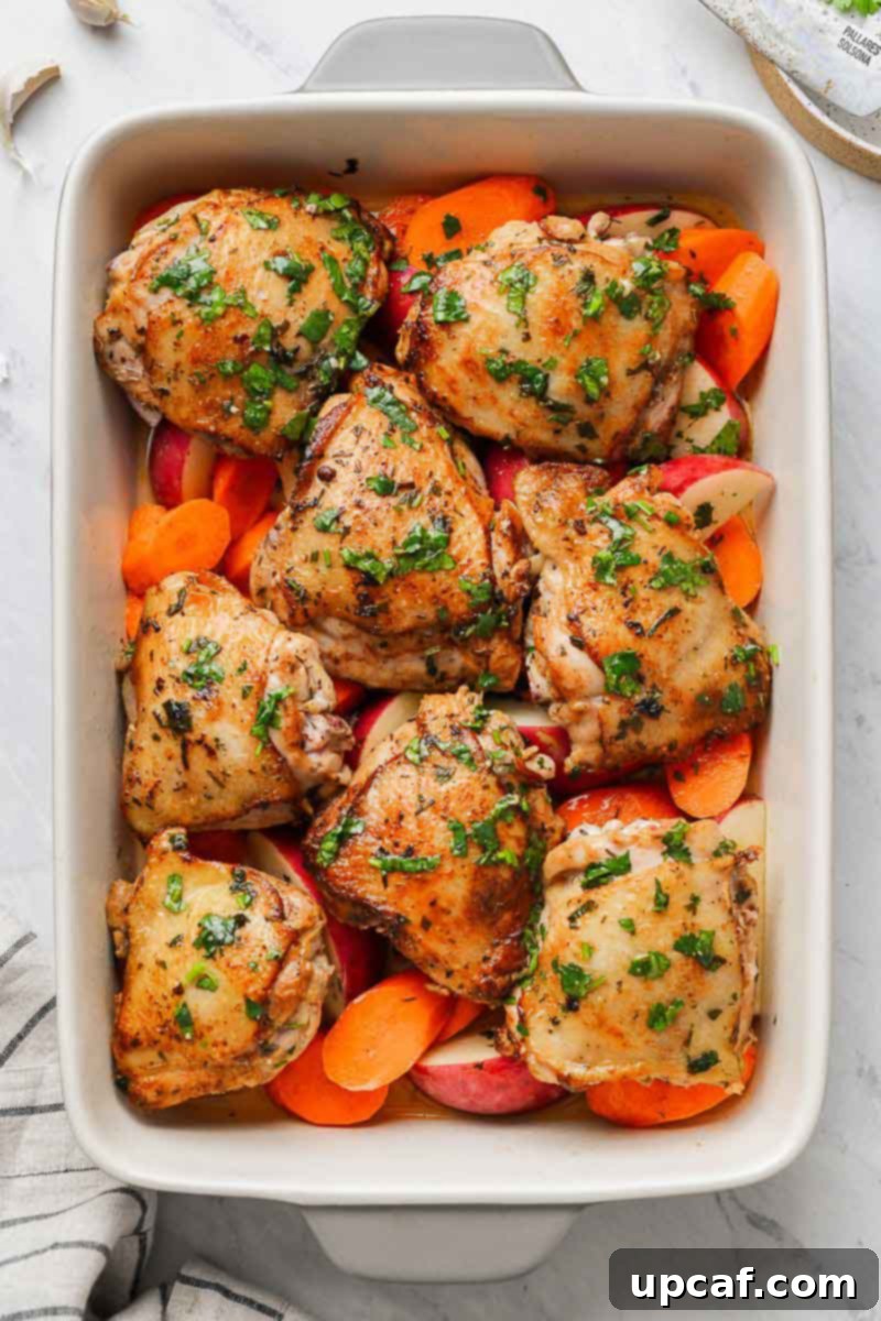 Zesty Lemon Cilantro Chicken 4 Chicken thighs arranged in a baking dish surrounded by prepped carrots and potatoes.
