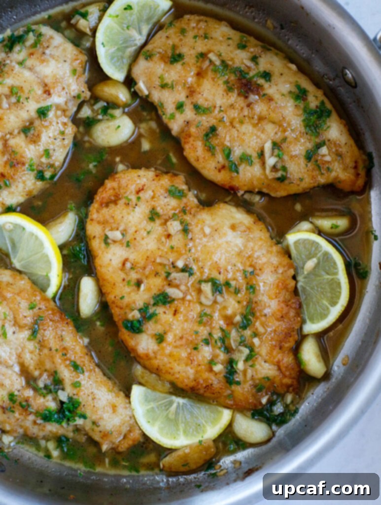 Overhead shot of lemon and garlic chicken in a skillet, showcasing the vibrant colors and appealing texture.