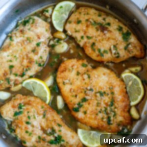 Top down shot of lemon and chicken in a skillet, ready to serve.