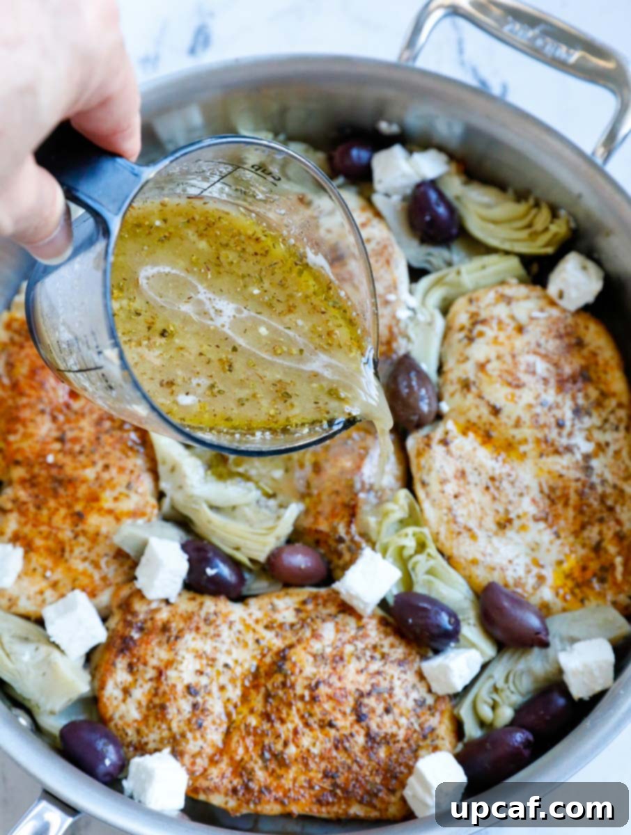 Pouring Greek marinade onto chicken and vegetables in a pot.