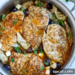 Top down shot of greek chicken in a skillet.