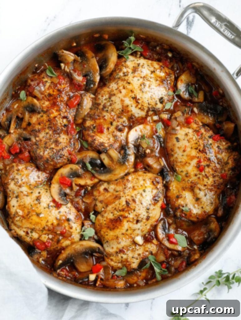 Creamy Tuscan Chicken Thighs 7 Top down shot of finished Tuscan chicken, bubbling in the skillet.