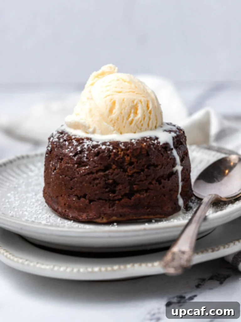 A perfectly baked molten chocolate lava cake topped with a scoop of vanilla ice cream.