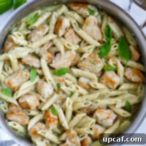 Creamy pesto chicken pasta in a pan.