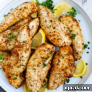 Top down view of lemon pepper chicken on a plate.