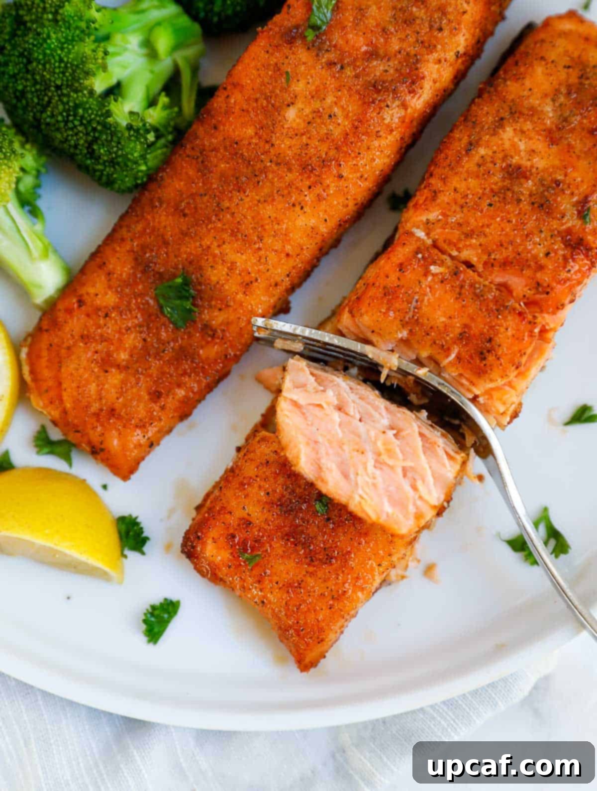 cutting into an air fried salmon