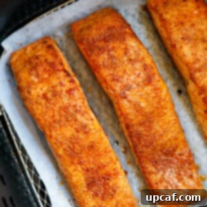 Cooked salmon fillets in an air fryer.