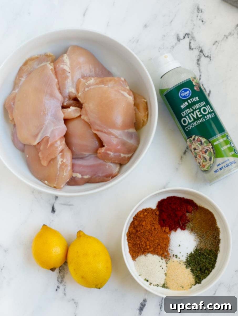 Crispy Juicy Air Fryer Boneless Thighs 3 Ingredients for air fryer boneless chicken thighs, including fresh lemons and various spices.