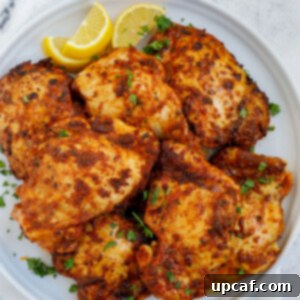 Crispy Juicy Air Fryer Boneless Thighs 9 Overhead shot of air fryer boneless chicken thighs on a plate.