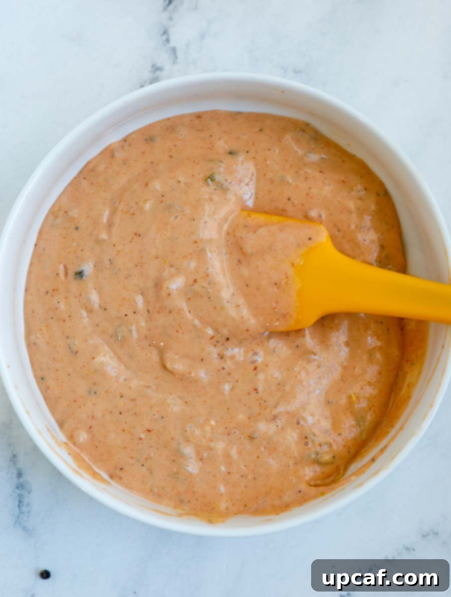 Hand mixing the special dipping sauce ingredients in a bowl until smooth.