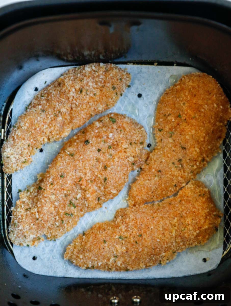 Cooked air fryer chicken tenders showing a golden, crispy top-down view.