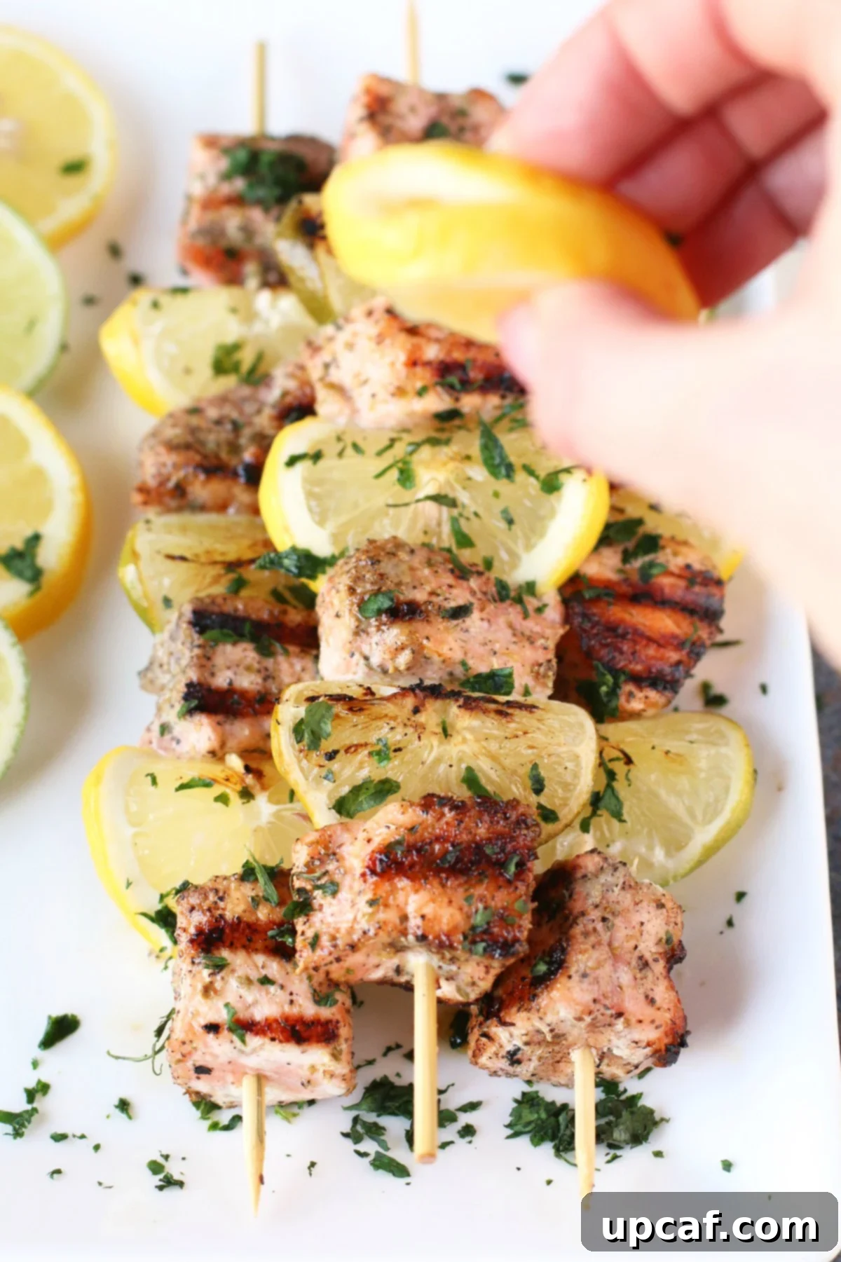 Zesty Salmon Kebabs 4 Squeezing fresh lime over grilled salmon skewers