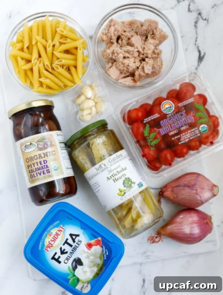 Overhead shot of all fresh ingredients laid out for making pasta salad.