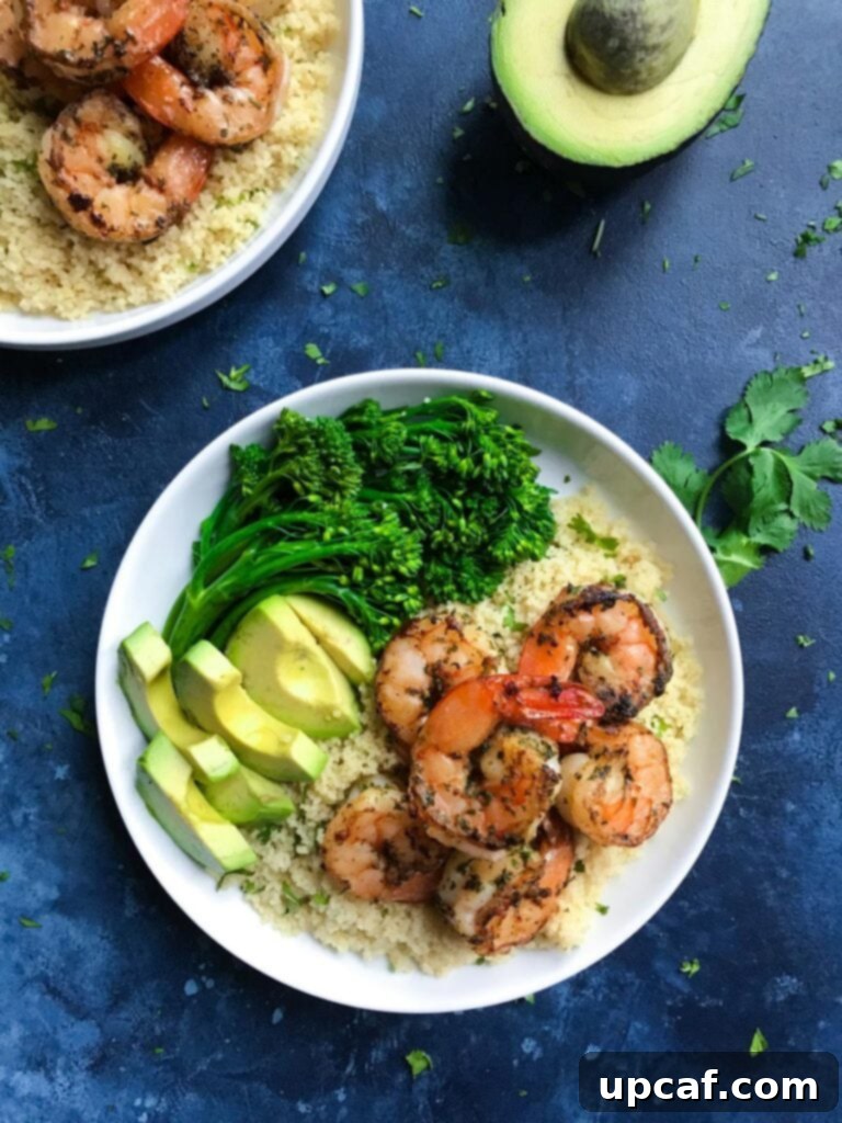 Bright Cilantro Lime Shrimp 3 Cilantro lime shrimp served with broccolini and avocado on a plate.