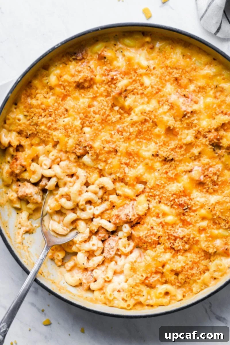 Top-down shot of the baked Cajun Chicken Mac and Cheese in a skillet, garnished and ready.