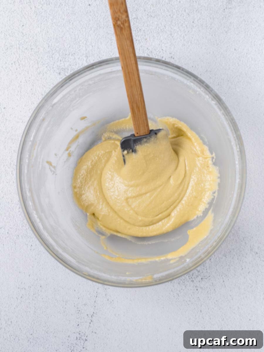 Close-up of lemon macaron batter showing the 'ribbon stage' consistency