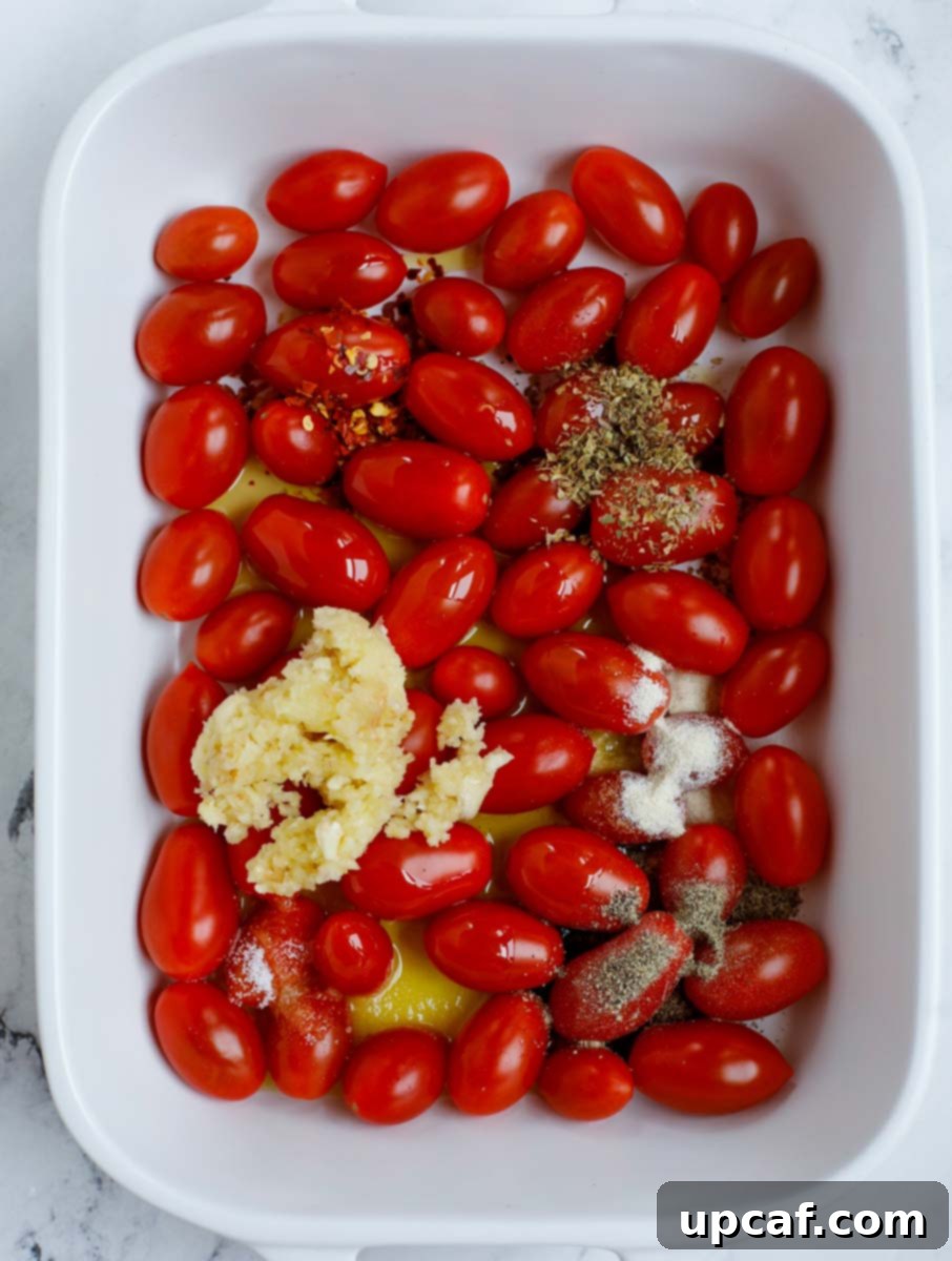 Golden Feta Pasta Bake 4 Cherry tomatoes in a baking dish seasoned with olive oil and spices.