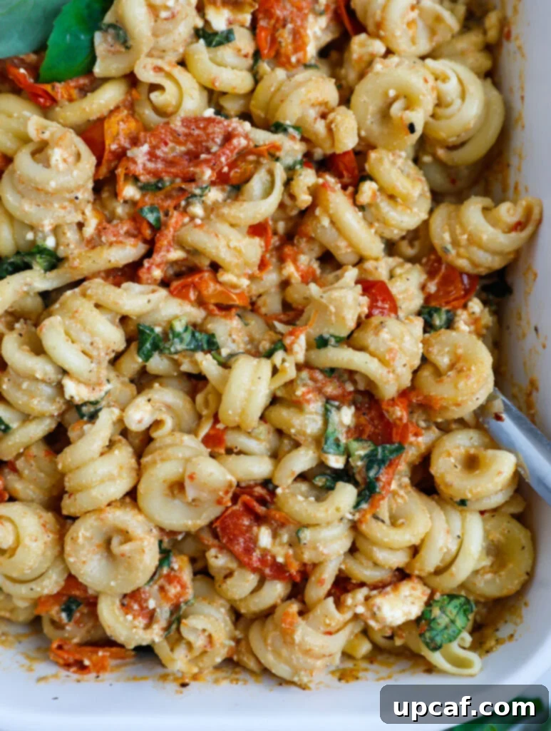 Golden Feta Pasta Bake 8 Close up of a baked feta pasta in a baking dish, ready to be served.