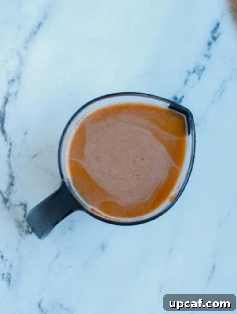 General Tso's sauce ingredients mixed in a measuring cup, ready for cooking.