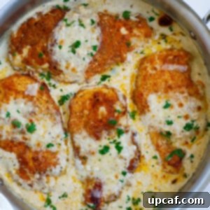 Skillet filled with creamy Caesar chicken, rich sauce, and melted cheese, ready to be served.